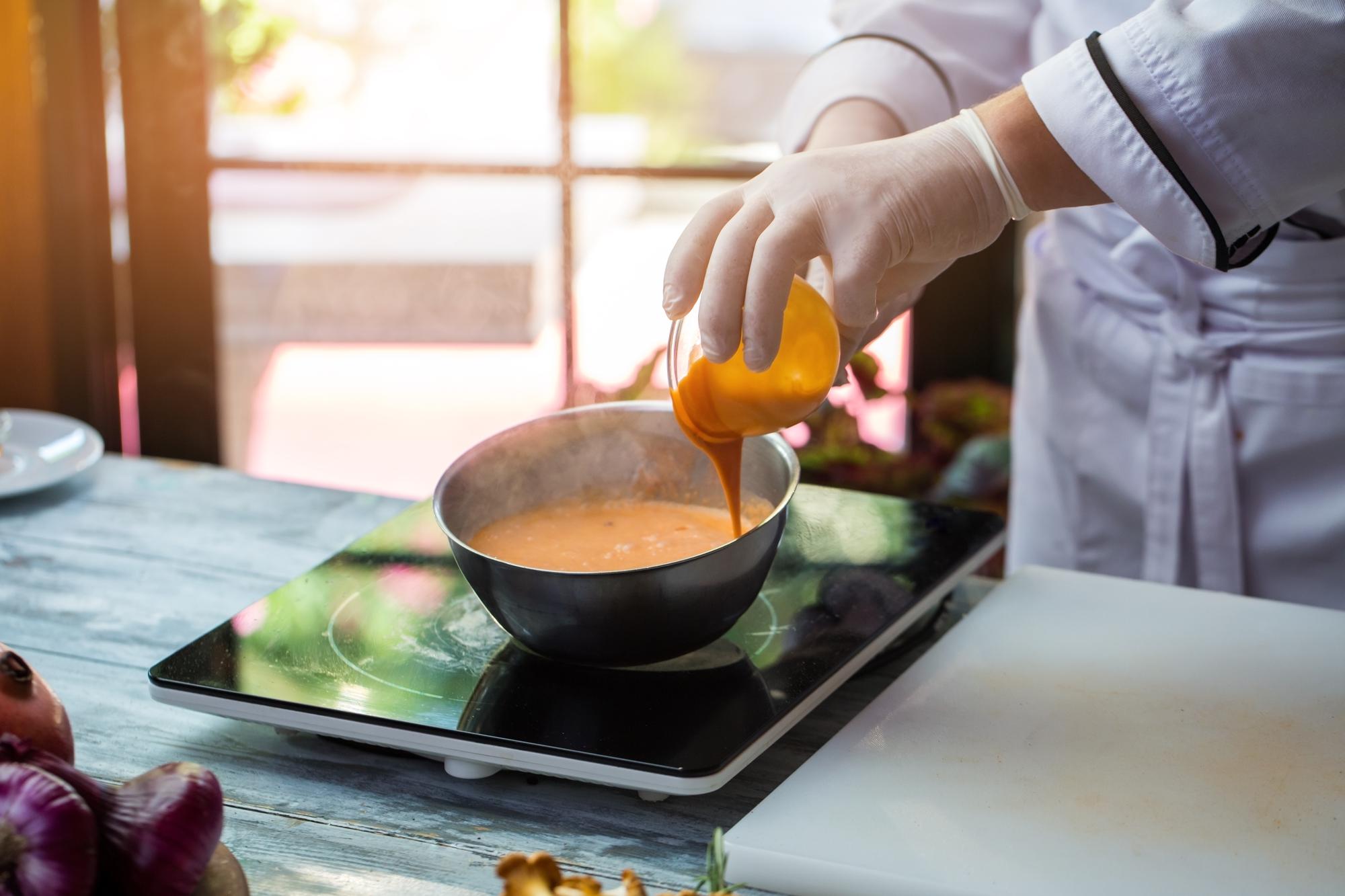 Student preparing sauce in studio